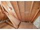 Exposed attic with wooden rafters and some wood flooring, lit by a single light bulb at 803 Woodmoore Ln, Kannapolis, NC 28081