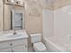 Standard bathroom featuring a vanity, toilet, and shower-tub combo with neutral-colored walls at 803 Woodmoore Ln, Kannapolis, NC 28081