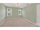 Bedroom featuring carpet, two windows, neutral paint and a chandelier at 803 Woodmoore Ln, Kannapolis, NC 28081