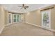 Spacious bedroom with carpet, a ceiling fan and natural light from three windows at 803 Woodmoore Ln, Kannapolis, NC 28081