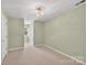Bedroom with neutral carpet, light green walls, ceiling light, and a window at 803 Woodmoore Ln, Kannapolis, NC 28081