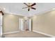 Bright bedroom featuring neutral walls, carpet, ceiling fan, and access to bathroom and closet at 803 Woodmoore Ln, Kannapolis, NC 28081