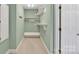 Walk-in closet with custom built-in shelving, rods, and storage space with access door at 803 Woodmoore Ln, Kannapolis, NC 28081