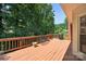 Spacious wood deck with seating and a grill offering lush backyard views at 803 Woodmoore Ln, Kannapolis, NC 28081