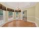 Bright dining area with wood floors, a chandelier, and views of the backyard at 803 Woodmoore Ln, Kannapolis, NC 28081