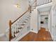 Entryway featuring hardwood floors, carpeted staircase, and hallway at 803 Woodmoore Ln, Kannapolis, NC 28081