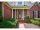 Inviting brick front porch with white columns and a charming entrance at 803 Woodmoore Ln, Kannapolis, NC 28081