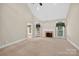 Open living room with vaulted ceiling, fireplace, and neutral carpet at 803 Woodmoore Ln, Kannapolis, NC 28081