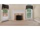 Inviting living room with a classic fireplace and access to the outdoor deck at 803 Woodmoore Ln, Kannapolis, NC 28081