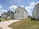 Two-story home with neutral siding, a two-car garage, and a well-maintained front yard at 835 Windage Way, Pineville, NC 28134
