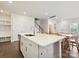 Kitchen island with stainless steel dishwasher, white cabinets, and faucet leading to the living and dining areas at 835 Windage Way, Pineville, NC 28134