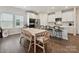 Bright kitchen features an island with seating, stainless steel appliances, and an adjacent dining area at 835 Windage Way, Pineville, NC 28134