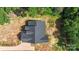 Aerial view of new construction home with dark roof and wooded surroundings at 8680 Sherrills Ford Rd, Sherrills Ford, NC 28673