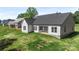 Aerial view of back exterior with modern white siding and spacious grassy yard at 8680 Sherrills Ford Rd, Sherrills Ford, NC 28673