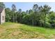 Expansive backyard with lush green grass, mature trees, and partial views of the home's exterior at 8680 Sherrills Ford Rd, Sherrills Ford, NC 28673