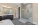 Bright bathroom features a glass shower, dual sinks, and access to a walk-in closet at 8680 Sherrills Ford Rd, Sherrills Ford, NC 28673