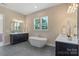 Elegant bathroom with a modern tub, dual sinks, and large windows providing ample natural light at 8680 Sherrills Ford Rd, Sherrills Ford, NC 28673
