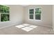 Sunlit bedroom with plush carpet and ample natural light streaming through bright windows at 8680 Sherrills Ford Rd, Sherrills Ford, NC 28673