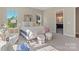Sunlit bedroom boasts neutral decor, stylish furnishings, and an en-suite bathroom for a relaxing retreat at 8680 Sherrills Ford Rd, Sherrills Ford, NC 28673
