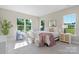 Bright bedroom featuring large windows, neutral tones, and stylish decor with serene outdoor views at 8680 Sherrills Ford Rd, Sherrills Ford, NC 28673