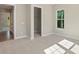 Inviting bedroom with neutral carpet and paint and a large window showcasing backyard at 8680 Sherrills Ford Rd, Sherrills Ford, NC 28673