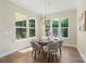 Bright dining room with large windows, hardwood floors, and a modern pendant light fixture at 8680 Sherrills Ford Rd, Sherrills Ford, NC 28673