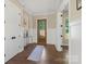 Entryway view with hardwood floors, white wainscoting, and a glass-paneled front door at 8680 Sherrills Ford Rd, Sherrills Ford, NC 28673