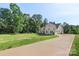 A beautiful home showcasing a long driveway and well-maintained lawn at 8680 Sherrills Ford Rd, Sherrills Ford, NC 28673
