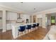 A stunning kitchen featuring a spacious island with seating, white cabinets, and modern pendant lighting at 8680 Sherrills Ford Rd, Sherrills Ford, NC 28673