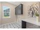 Well-lit laundry room with stylish tile, modern cabinets, and convenient workspace at 8680 Sherrills Ford Rd, Sherrills Ford, NC 28673
