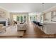 Bright, open-concept living room with a fireplace, flowing into a modern kitchen with a large island and dining area at 8680 Sherrills Ford Rd, Sherrills Ford, NC 28673