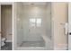 Modern shower with herringbone tile, glass enclosure, and built-in bench for a spa-like experience at 8680 Sherrills Ford Rd, Sherrills Ford, NC 28673