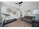 Bonus room offers flexible space, complete with exercise equipment and a cozy seating area at 8702 Aspinwall Dr, Charlotte, NC 28216