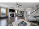 Open living room with hardwood floors, fireplace, large TV, and ample seating at 8702 Aspinwall Dr, Charlotte, NC 28216