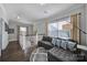 This is a living room with wood floors, gray sofa, nice windows, and staircase view at 8702 Aspinwall Dr, Charlotte, NC 28216