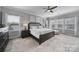 Spacious main bedroom boasts multiple windows, soft carpet, and a luxurious ambiance at 8702 Aspinwall Dr, Charlotte, NC 28216