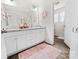 Bathroom with a double vanity, granite countertop, and updated fixtures at 9025 Henry Thoreau Rd, Charlotte, NC 28214
