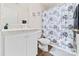 Bathroom features white cabinets and a combination tub and shower at 9025 Henry Thoreau Rd, Charlotte, NC 28214