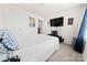 Comfortable bedroom features neutral carpet, a double door closet, and television at 9025 Henry Thoreau Rd, Charlotte, NC 28214