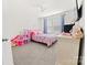 bedroom features neutral carpeting and an accent wall at 9025 Henry Thoreau Rd, Charlotte, NC 28214