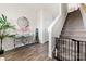 Inviting foyer with elegant console table and decorative mirror and stairway with pet gate at 9025 Henry Thoreau Rd, Charlotte, NC 28214