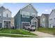 Beautiful two-story home with blue siding, a well-kept lawn, and an attached garage in a desirable neighborhood at 9025 Henry Thoreau Rd, Charlotte, NC 28214