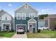Inviting two-story home with tidy front yard, complemented by a compact garage and charming curb appeal at 9025 Henry Thoreau Rd, Charlotte, NC 28214
