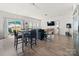 Bright and open living space with a dining table, modern furnishings, and a view of the backyard at 9025 Henry Thoreau Rd, Charlotte, NC 28214