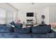 Bright living room featuring neutral walls, a comfortable sofa, and ample natural light from large windows at 9025 Henry Thoreau Rd, Charlotte, NC 28214