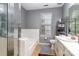 Bathroom features a shower/tub combo, white tile, and a vanity sink at 9520 Marshbrooke Rd, Matthews, NC 28105