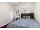 Bedroom features a checkered bedspread, two windows, and neutral walls at 9520 Marshbrooke Rd, Matthews, NC 28105