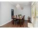 Elegant dining room with a chandelier, hardwood floors, and access to the backyard at 9520 Marshbrooke Rd, Matthews, NC 28105