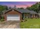 Charming brick home with a well-maintained lawn and attached garage at 9520 Marshbrooke Rd, Matthews, NC 28105