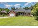 Well-kept single-story brick home featuring a lush green lawn and landscaping at 9520 Marshbrooke Rd, Matthews, NC 28105
